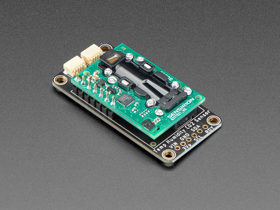 Angled shot of a Adafruit SCD-30 - NDIR CO2 Temperature and Humidity Sensor with tan JST connectors. 