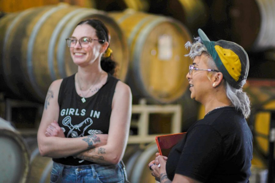 women talking in cellar room at brewery 1200x628 1
