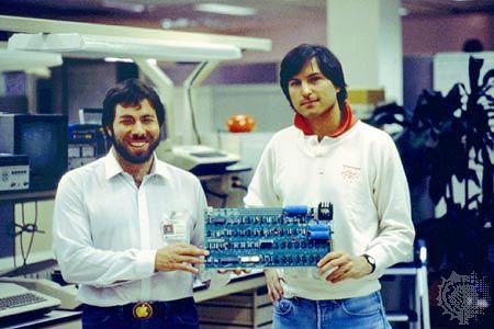 Steve Wozniak and Steve Jobs holding an Apple I circuit board in 1976