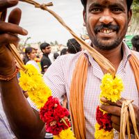 MADURAI, INDIA - JAN 15: A man offers a garland during Pongal harvest festival on January 15, 2014 in Madurai, Tamil Nadu, India.