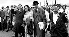 Martin Luther King Jr., and his wife, Coretta, lead off the final lap to the state capitol at Montgomery, Alabama on March 25, 1965. Thousands of civil rights marchers joined in the walk, which began in Selma, demanding voter registration rights