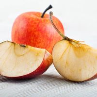 Slices of ripe apples on a wooden table