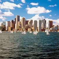 Sailboats in Boston Harbor in front of the financial district of Boston, Massachusetts, USA