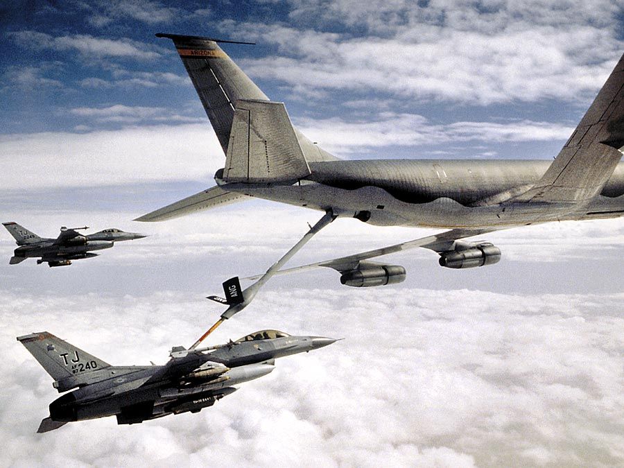 KC-135 Stratotanker refueling U.S. Airforce military F-16 Falcon. Transportation aircraft refueled in mid-air aka aerial refueling.