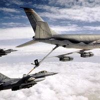 KC-135 Stratotanker refueling U.S. Airforce military F-16 Falcon. Transportation aircraft refueled in mid-air aka aerial refueling.