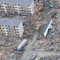 An Air Force search and rescue team in an HH-60 G Pave Hawk helicopter surveys the damage as it flies over Sendai, Japan, March 14, 2011. Japan 2011