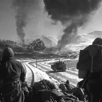 Korean War - U.S. Marines watch explosions of bombs dropped by Marine Vought F4U Corsair fighter bomber planes during the Battle of Chosin Reservoir, Korea, in December 1950. soldiers