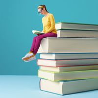 Woman reading while perched on the edge of a blown-up stack of books.