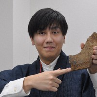 摩耶山で回収した模擬原爆の一部の可能性がある金属片を示す西岡孔貴さん＝神戸市灘区で2024年2月15日午後5時38分、関谷徳撮影