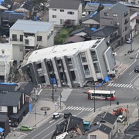 能登半島地震から4カ月がたっても横倒しのままのビル＝石川県輪島市で2024年5月1日、本社ヘリから北村隆夫撮影