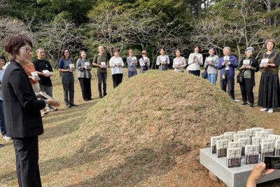 大河小説「土地」の日本語翻訳本を手に20巻完訳を朴景利（パク・キョンニ）さんの墓前に報告するクオンの金承福（キム・スンボク）代表（左端）と読者ら＝韓国南部の統営市で2024年10月19日、堀山明子撮影