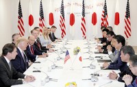 In this June 28, 2019, file photo, then-U.S. President Donald Trump, second from left, meets Japanese Prime Minister Shinzo Abe, third from right, at the Intex Osaka convention center in Osaka's Suminoe Ward. (Pool photo)