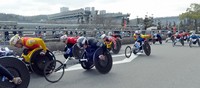 Contestants start competing at the Emperor's Cup National Wheelchair Ekiden race, with the Kyoto International Conference Center in the background, in Kyoto's Sakyo Ward on March 9, 2014. (Mainichi/Michiko Morizono)