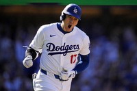  Los Angeles Dodgers' Shohei Ohtani celebrates as he heads to first for a solo home run during the ninth inning of a baseball game against the Colorado Rockies, on Sept. 22, 2024, in Los Angeles. (AP Photo/Mark J. Terrill, File)