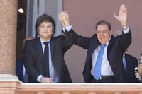 Venezuela's opposition leader Edmundo Gonzalez Urrutia, right, and Argentine President Javier Milei hold hands from the government house balcony in Buenos Aires, Argentina, on Jan. 4, 2025. (AP Photo/Natacha Pisarenko)