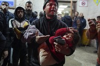 A man reacts while carrying a wounded girl to Al-Aqsa Martyrs Hospital following Israeli army airstrikes in Deir al-Balah, central Gaza Strip,on Jan. 4, 2025.(AP Photo/Abdel Kareem Hana)