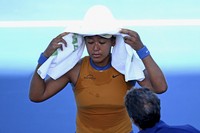 Japan's Naomi Osaka reacts after deciding to retire from the ASB Classic final against Denmark's Clara Tauson due to injury on Jan. 5, 2025, in Auckland, New Zealand. (Getty/Kyodo)