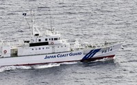 This photo taken from a Kyodo News helicopter shows a Japan Coast Guard patrol boat searching for crew members of a capsized fishing boat off the Port of Kashima, Ibaraki Prefecture, on Jan. 6, 2025. (Kyodo)