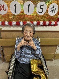 Okagi Hayashi poses for a photo upon being congratulated on her 115th birthday. (Photo courtesy of her family)