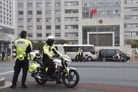 Police guard the Suzhou Intermediate People's Court in Suzhou in China's Jiangsu Province on Jan. 23, 2025. (Kyodo)