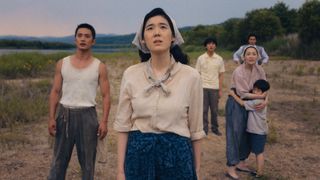 A group of farmers look on at something happening off camera in Pachinko season 2 on Apple TV Plus