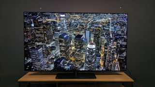 Philips OLED808 with aerial shot of city at night on screen