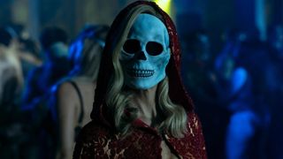 A woman wearing a skull mask during a party in the Netflix horror series, The Fall of the House of Usher.