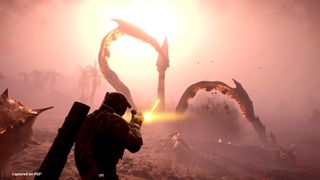 A player fires at tentacles bursting from the ground of a hazy red planet