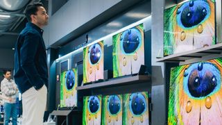 Man shopping for TVs in store