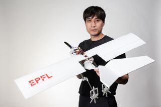 Researcher holding the robot bird.