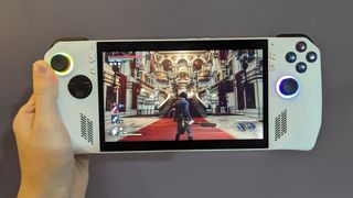 Best Handheld Gaming Devices 2024 - Asus ROG Ally Z1 in our hands while overlooking a red, white, and gold cathedral in Lies of P.