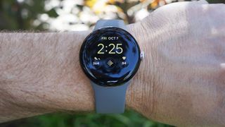 Google Pixel Watch on a person's wrist, the screen is facing us with the time on it (it's 2:25)