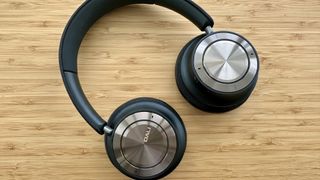 Dali IO-8 over-ear headphones on a wood surface