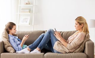 mom and daughter on cellphones.