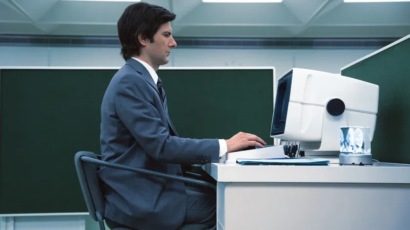 Adam Scott as Mark S. looking at a Lumon computer