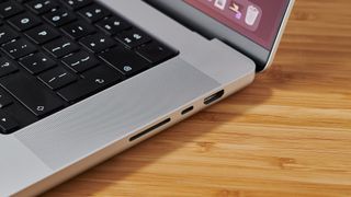 MacBook Pro 16-inch on wooden table in modern office