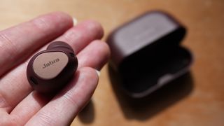 A hand holding the Jabra Elite 10