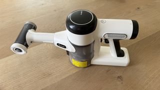 white handheld vacuum on wooden table