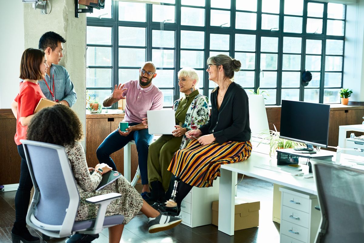 Diverse group of mixed age and multi ethnic colleagues in discussion in an office setting