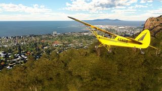 Microsoft Flight Simulator Australia screenshot of a yellow airplane flying through a photorealistic green township