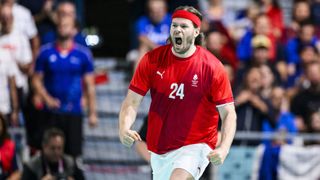 Mikkel Hansen of Denmark celebrates during the Men&#039;s Preliminary Round Group B, dressed all in red, at the 2024 Paris Olympic Games.