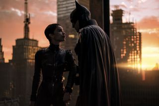 Batman grabs Selina Kyle's arm during a tense confrontation in The Batman movie