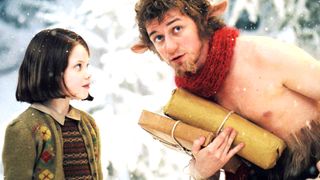 James McAvoy as Mr. Tumnus and Georgie Henley as Lucy Pevensie standing in the snow during the movie The Chronicles of Narnia: The Lion, the Witch and the Wardrobe.