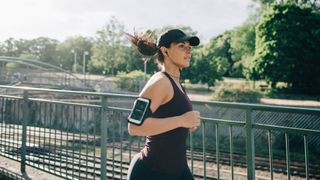 Caucasian woman running to music