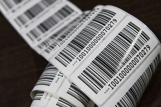 A close up image of a roll of sticker barcodes