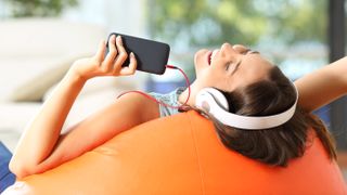 Young woman listening music with headphones