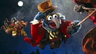 Gonzo and Rizzo the Rat holding onto a rope during the Disney movie The Muppet Christmas Carol.