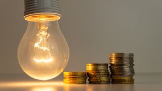 Bulb next to a stack of coins