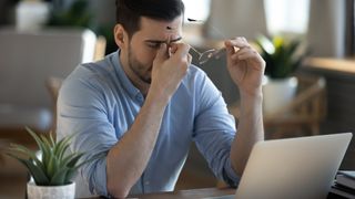 Relieved man by laptop