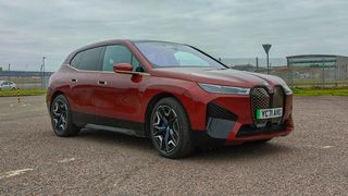 Red BMW iX parked outside an airport